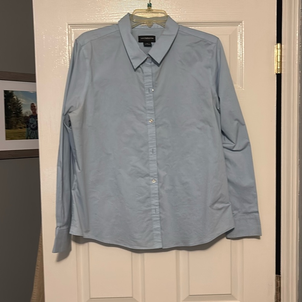 Long sleeve light blue shirt with collar.